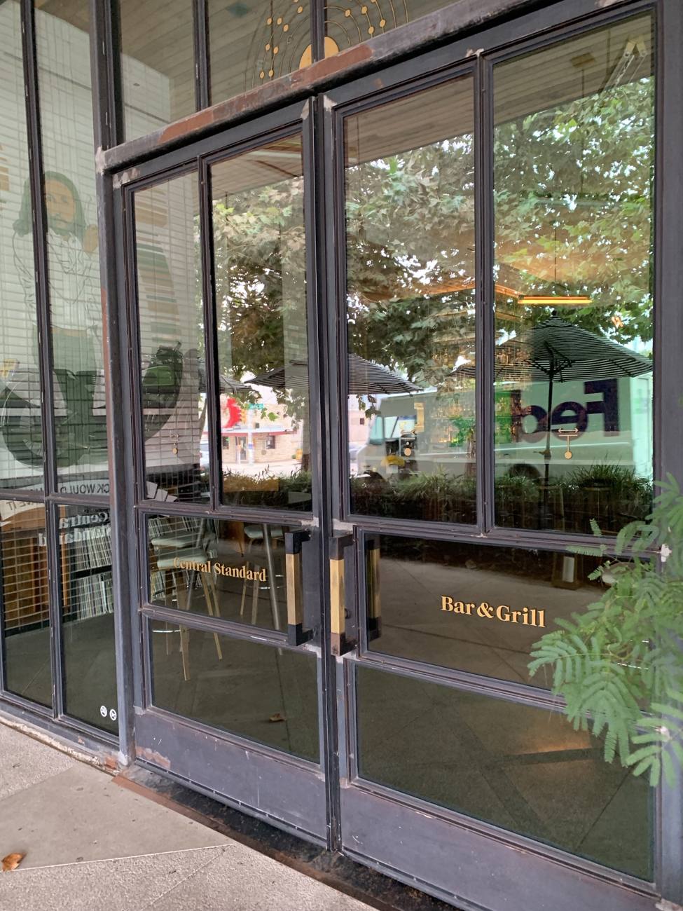 Steel restaurant entry doors with gold lettering